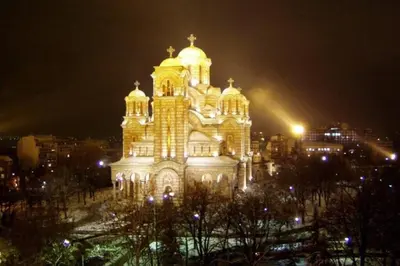 a large building with lights on it at night at St. Marko studio in Belgrade