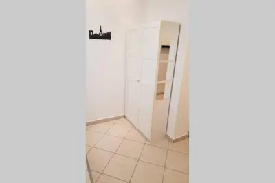 a room with a white closet and a mirror at St. Marko studio in Belgrade