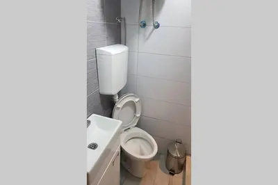 a bathroom with a toilet and a sink at St. Marko studio in Belgrade