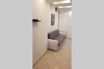 a waiting room with a couch in a hallway at St. Marko studio in Belgrade