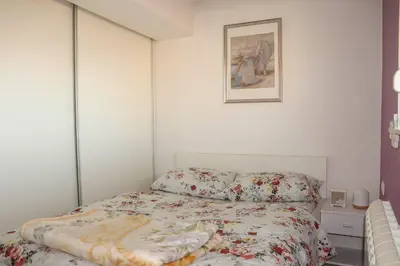 a bedroom with a bed and a picture on the wall at Juventas37 in Belgrade
