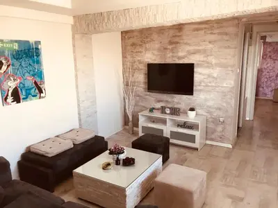 a living room with a couch and a tv at Juventas37 in Belgrade