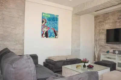 a living room with two couches and a tv at Juventas37 in Belgrade