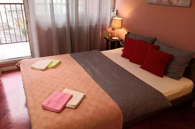 a bedroom with a large bed with two towels on it at Studio Prim in Belgrade