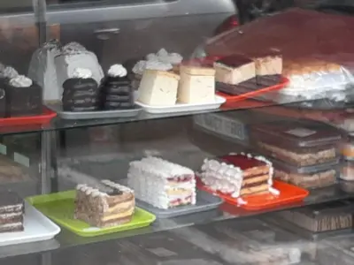 a display case with different types of cakes and desserts at Studio Prim in Belgrade