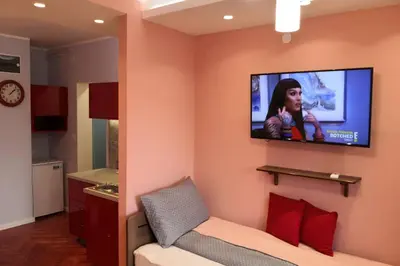 a living room with a tv on a wall at Studio Prim in Belgrade