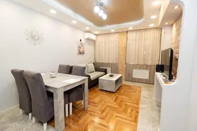 a living room with a table and a couch at New Belgrade Center 2 in Belgrade