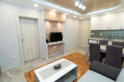 a living room with a television and a dining room at New Belgrade Center 2 in Belgrade