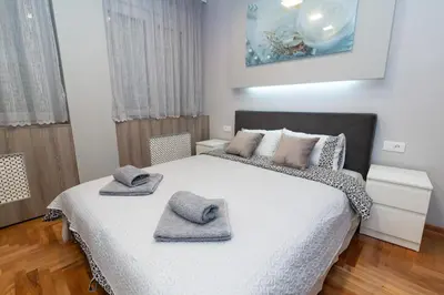 a bedroom with a large bed with towels on it at New Belgrade Center 2 in Belgrade