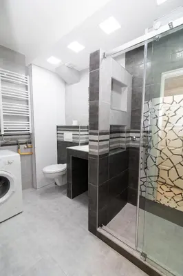 a bathroom with a toilet and a glass shower at New Belgrade Center 2 in Belgrade