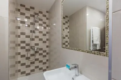 a bathroom with a shower and a sink at Premium Crown Suites in Belgrade