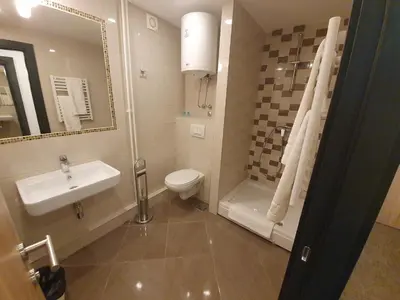 a bathroom with a sink and a toilet and a shower at Premium Crown Suites in Belgrade