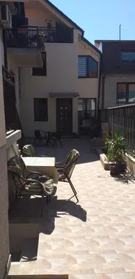 a patio with chairs and a table and a building at A modest place in Belgrade