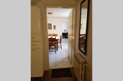 a hallway leading into a dining room with a table at A modest place in Belgrade