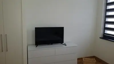 a flat screen tv sitting on top of a white dresser at Belgrade Waterfront Lux 2 in Belgrade