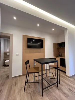 a dining room with a black table and chairs at Villa Ponte in Pančevo