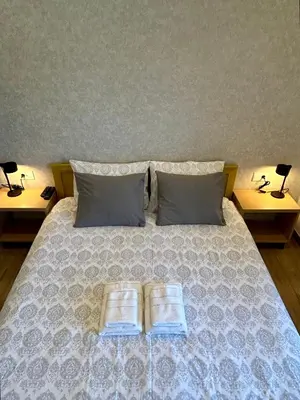 a bedroom with a bed with two books on it at Villa Ponte in Pančevo