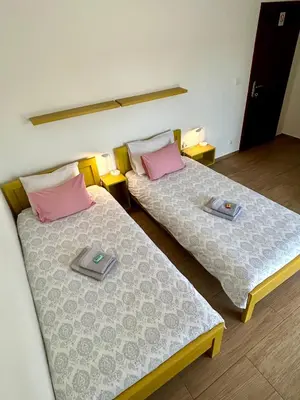two beds sitting next to each other in a room at Villa Ponte in Pančevo