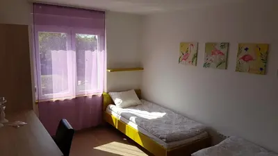 a small room with a bed and a window at Villa Ponte in Pančevo