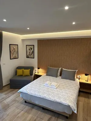 a bedroom with a large bed and a couch at Villa Ponte in Pančevo