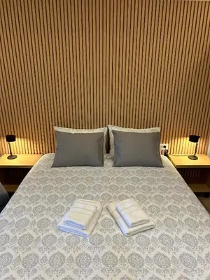 a bedroom with a bed with two towels on it at Villa Ponte in Pančevo