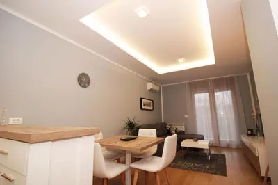 a kitchen and living room with a table and chairs at Apartment A block Daja in Belgrade