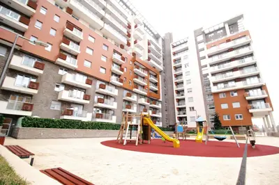 a playground with a slide in front of a building at Apartment A block Daja in Belgrade