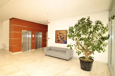 a lobby with a couch and a tree in it at Apartment A block Daja in Belgrade