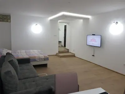 a living room with a couch and a tv at Apartman Viktor 2 Jacuzzi in Belgrade