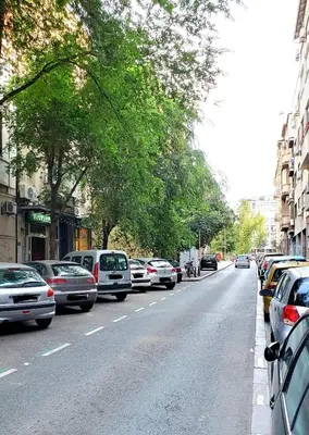 a street with cars parked on the side of the road at 1st Belgrade Apartment in Belgrade