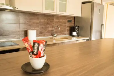 a kitchen counter with a cup of snacks on a table at Ahoy Belgrade Luxury Apartment in Belgrade