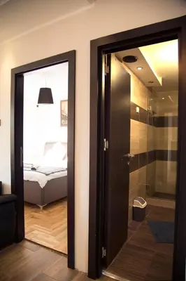 a bathroom with a glass door leading to a bedroom at Ahoy Belgrade Luxury Apartment in Belgrade