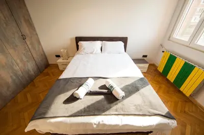 a bedroom with a bed with two towels on it at Ahoy Belgrade Luxury Apartment in Belgrade