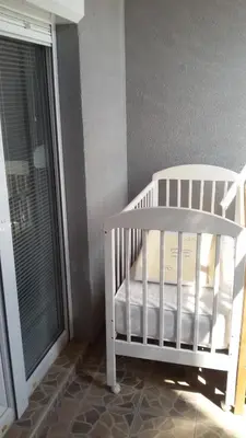 a white crib in a room with a window at Lili in Arandjelovac
