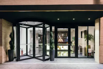 an entrance to a store with glass doors at Central Point Hotel Beograd in Belgrade