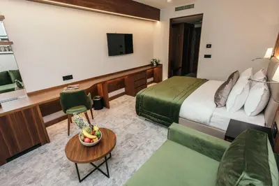 a hotel room with a bed and a table at Central Point Hotel Beograd in Belgrade