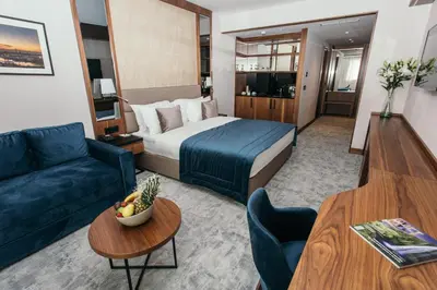 a hotel room with a bed and a couch at Central Point Hotel Beograd in Belgrade