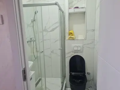 a bathroom with a toilet and a glass shower at EXCLUSIVE Apartment in Belgrade