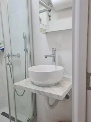 a bathroom with a white sink and a shower at EXCLUSIVE Apartment in Belgrade
