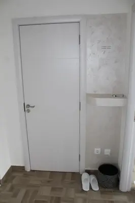 a room with a white door and two white shoes at EXCLUSIVE Apartment in Belgrade