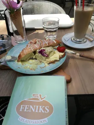 a table with a plate of food on a table at Liberty in Belgrade