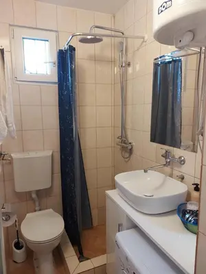 a bathroom with a toilet and a sink at Liberty in Belgrade