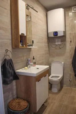 a bathroom with a white sink and a toilet at Comfortable apartment in city hub in Belgrade