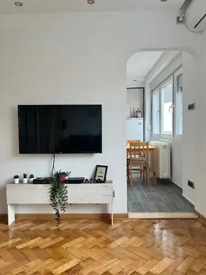 a living room with a large flat screen tv on a wall at Comfortable apartment in city hub in Belgrade