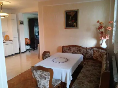 a living room with a table and a couch at VILA PEKEČ in Mala Moštanica