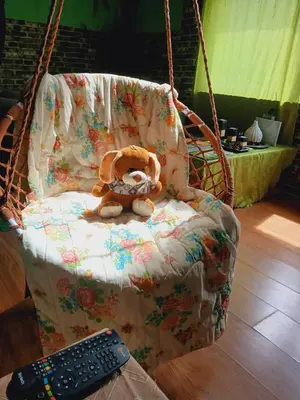 a stuffed teddy bear sitting in a swinging chair at Sunčana Strana Fruške Gore - veliko imanje sa kucom za odmor in Velika Remeta