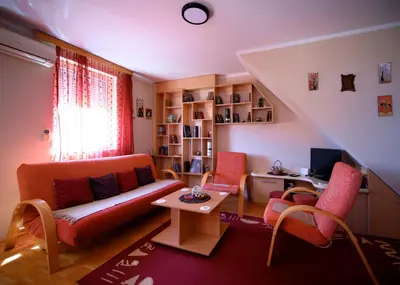 a living room with a couch and a table at Apartman 23 in Lazarevac