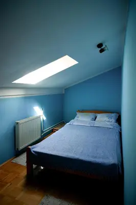 a blue bedroom with a bed with a blue ceiling at Apartman 23 in Lazarevac