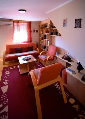 a living room with a couch and a table at Apartman 23 in Lazarevac