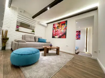 a living room with a couch and a table at Colorway Apartment in Belgrade